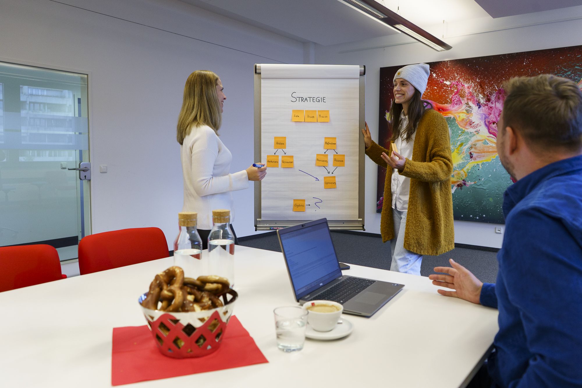 Three people in a brainstorming session.